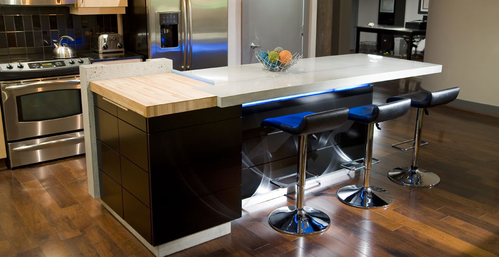 Concrete countertops and concrete kitchen island with under-lighting by Reaching Quiet Design | Concrete Exchange