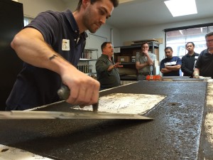 Clay troweling the backside of the concrete to create and even surface | CHENG Concrete Exchange