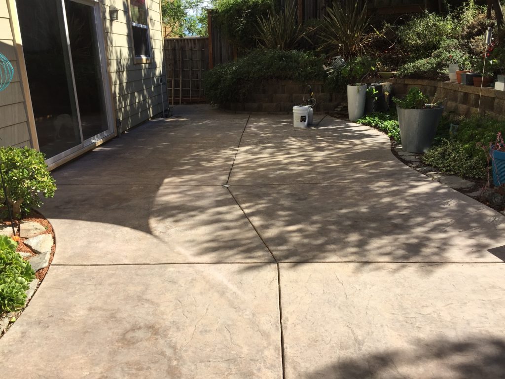 Weathered outdoor concrete patio, ready for restoration