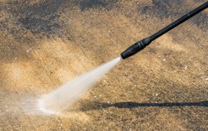 Pressure washing old concrete slab to clean and prep for sealer and stain